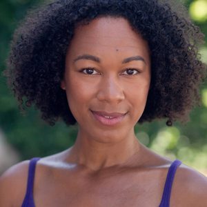 A persons headshot with them in the centre towards camera