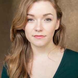 A persons headshot with them in the centre towards camera