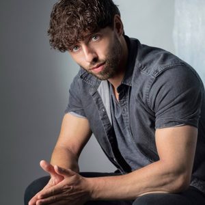 A persons headshot with them in the centre towards camera