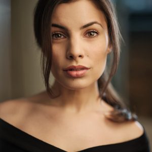 A persons headshot with them in the centre towards camera