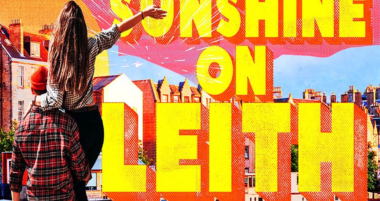 A man holding a woman in one arm facing away towards buildings with barges on a canal