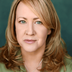 Headshot of Shona White - she has mid length blonde hair and is wearing a green shirt.