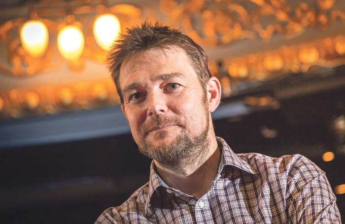 A bearded man in a checked shirt.