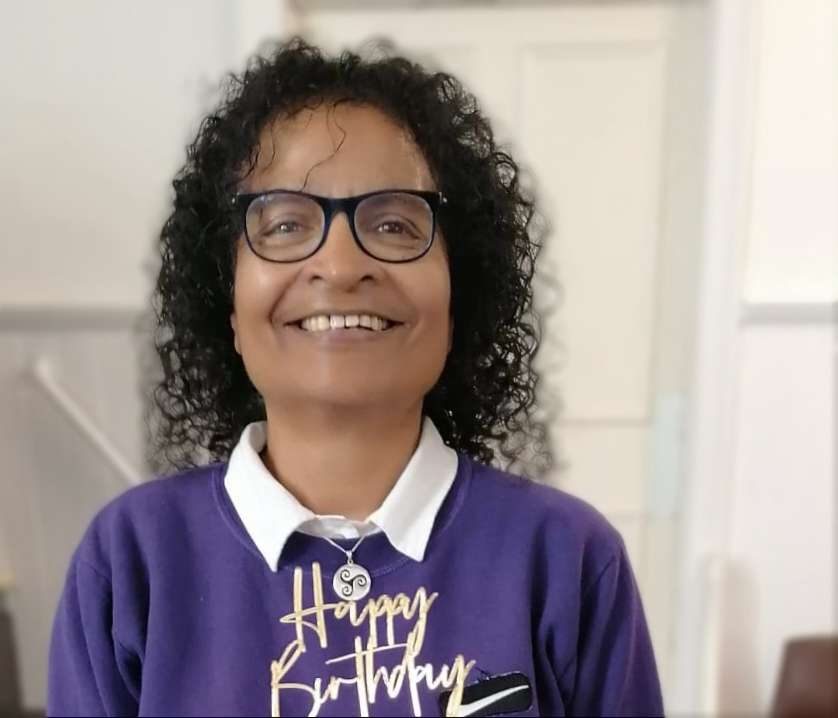 A woman in a purple sweater.