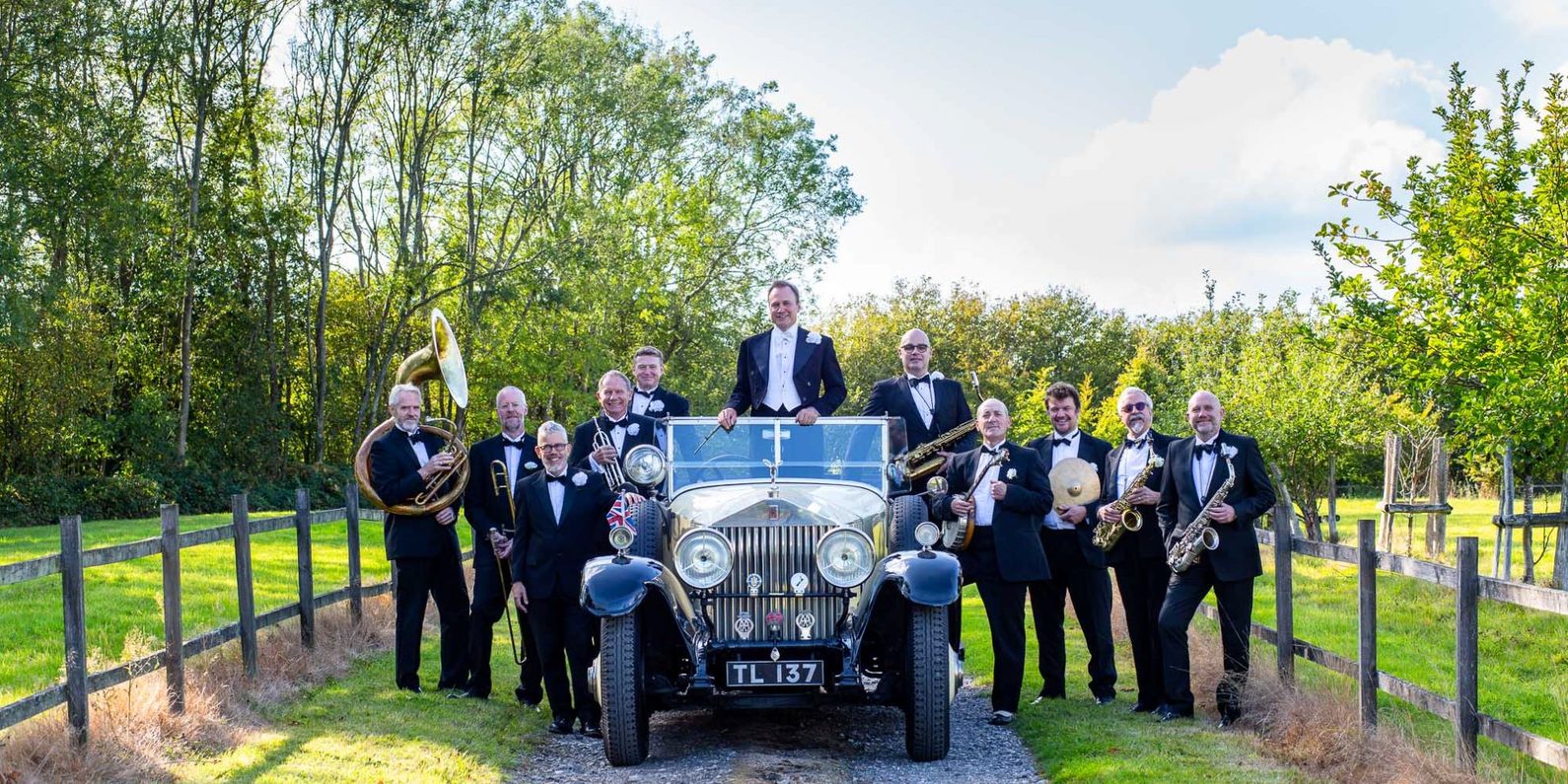 Vintage car surrounded by people in suits
