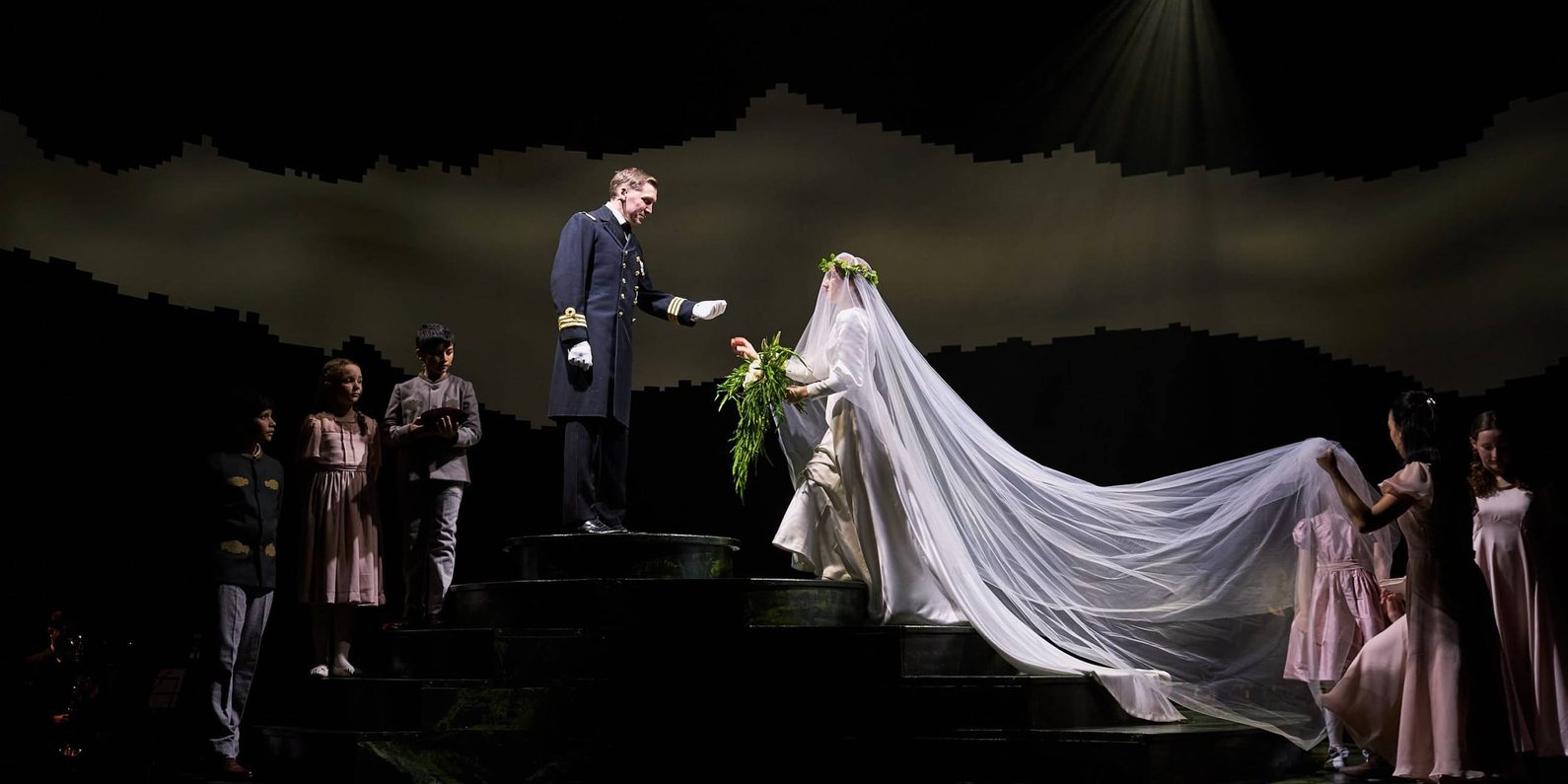 Actors in costume on stage in a wedding scene