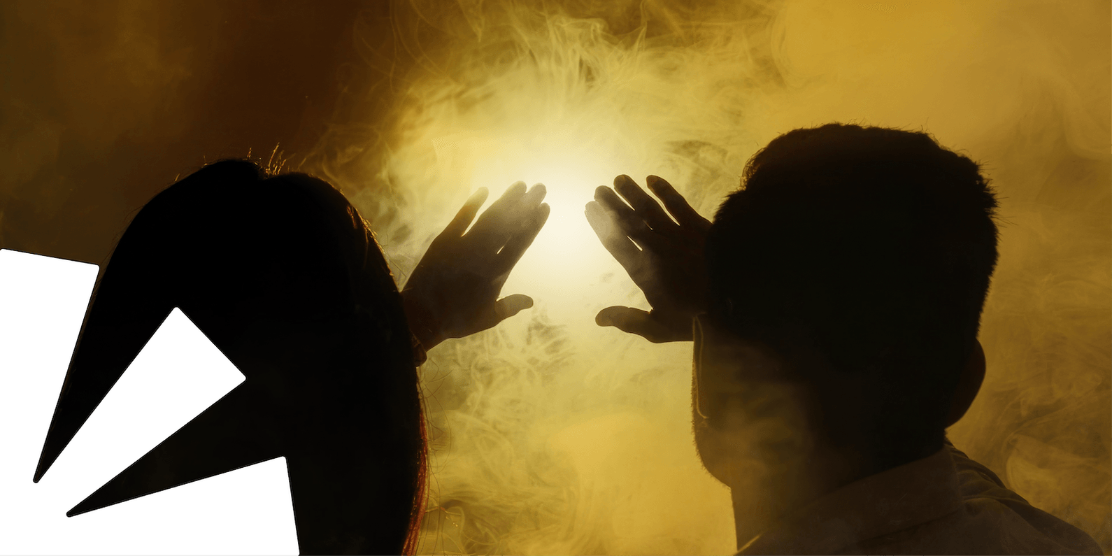 Two silhouettes with hands stretched towards a glowing light